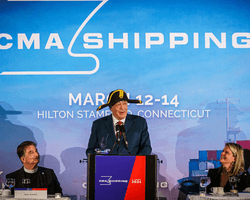 An image showing the CMA Commodore 2024, Michael D. Tusiani, delivering his speech to the CMA Shipping audience